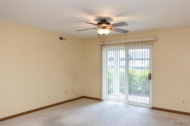 empty room featuring ceiling fan, light colored carpet, and baseboards