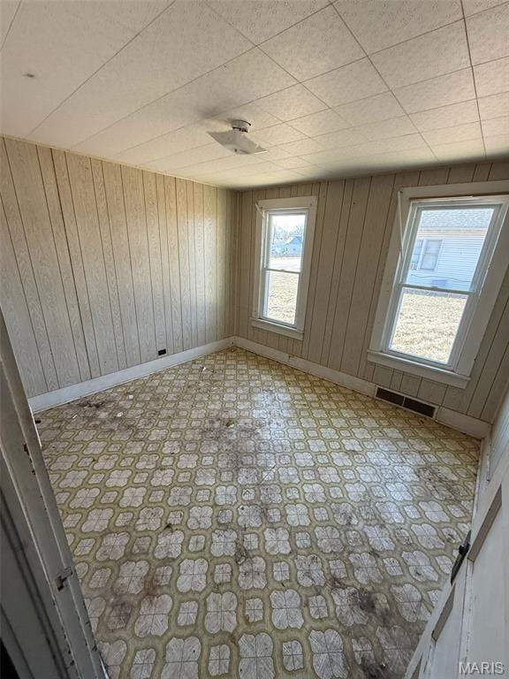 6966 Front St, Barnhart, MO 63012 - unfurnished room with light floors, baseboards, and wood walls