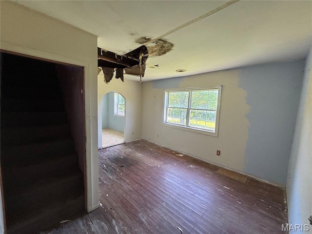 6966 Front St, Barnhart, MO 63012 - unfurnished room with arched walkways, hardwood / wood-style floors, and stairs