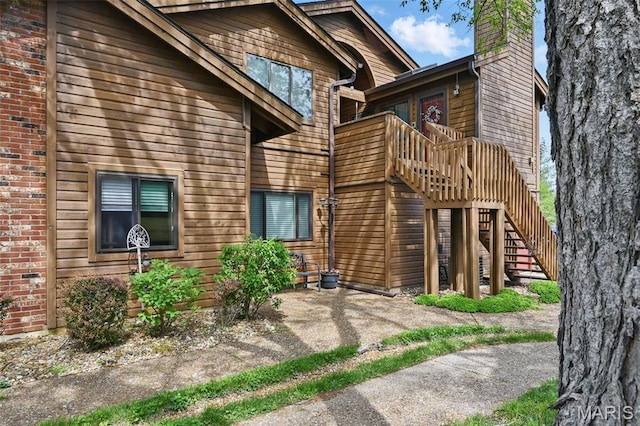 view of front of property with stairway and a chimney
