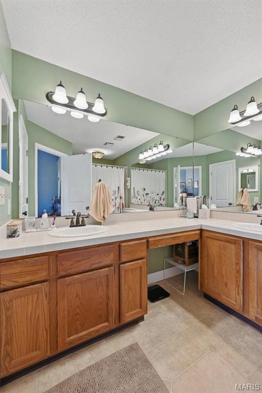 bathroom featuring double vanity and tile patterned floors