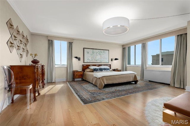 900 S Hanley Rd Unit 15E, Clayton, MO 63105 - bedroom featuring ornamental molding, wood finished floors, and baseboards