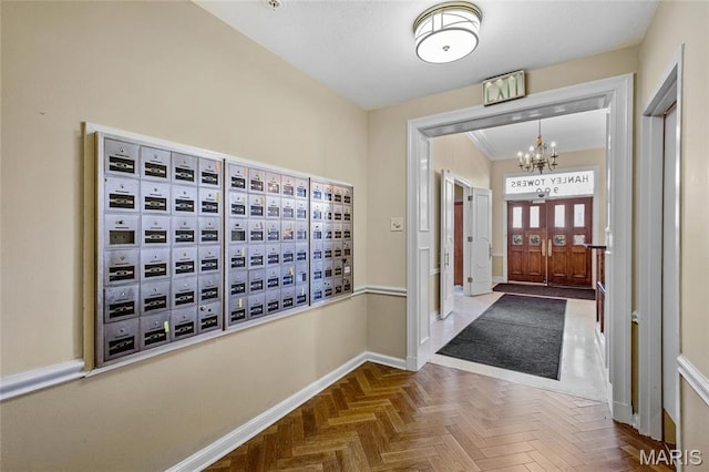 900 S Hanley Rd Unit 15E, Clayton, MO 63105 - foyer entrance with baseboards, a chandelier, and mail area