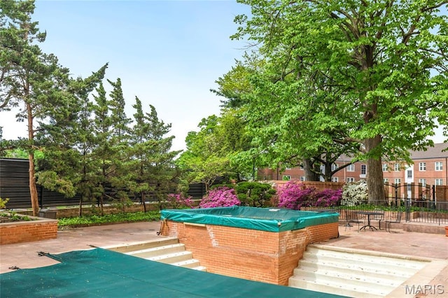 900 S Hanley Rd Unit 15E, Clayton, MO 63105 - surrounding community with fence, a pool, and a patio area