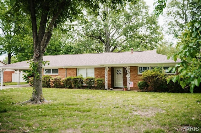 ranch-style home featuring a carport, a front yard, and brick siding