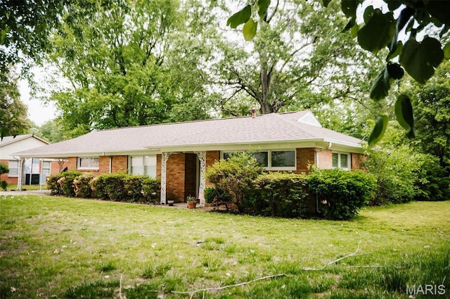 ranch-style home with brick siding and a front lawn