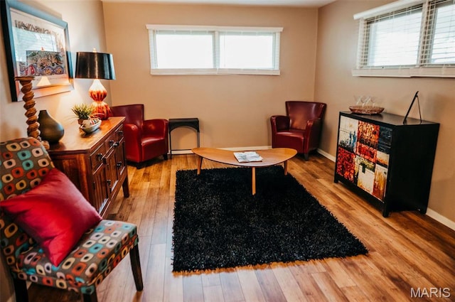 sitting room with wood finished floors and baseboards