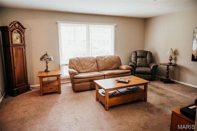 living area with light colored carpet and baseboards