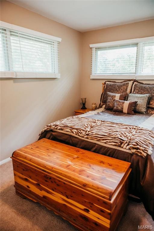 carpeted bedroom featuring baseboards