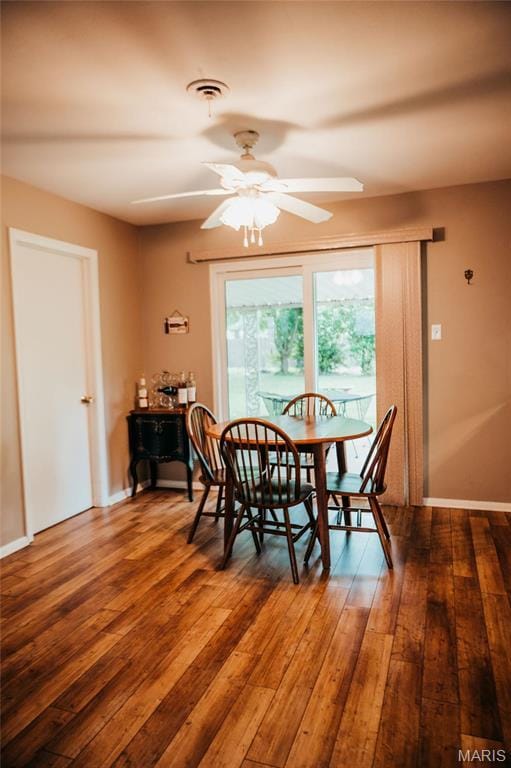 dining area with ceiling fan, hardwood / wood-style floors, and baseboards