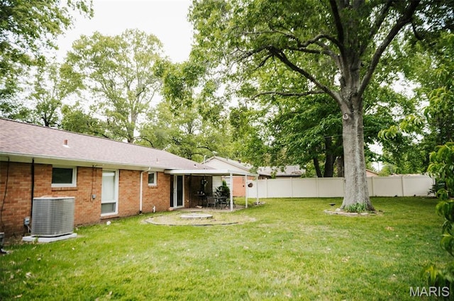 view of yard featuring central air condition unit and a patio area