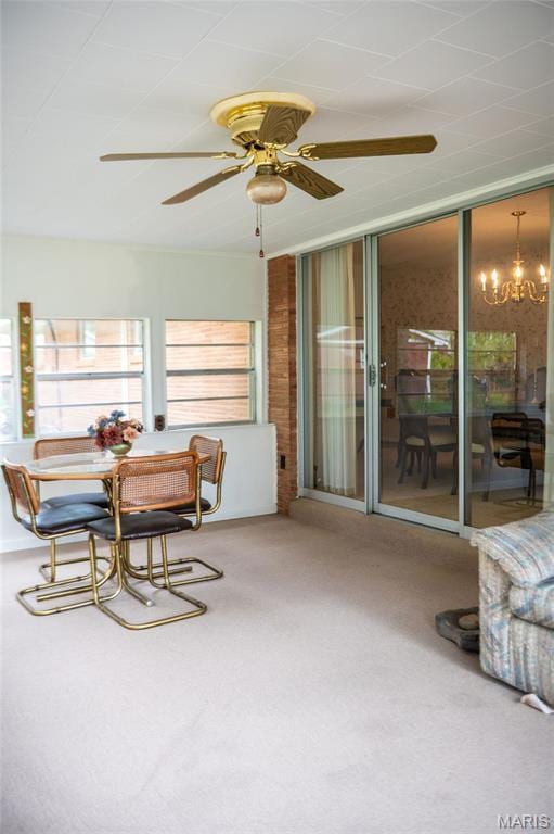 sunroom / solarium with a chandelier