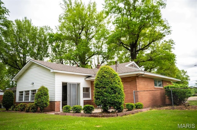 single story home featuring brick siding