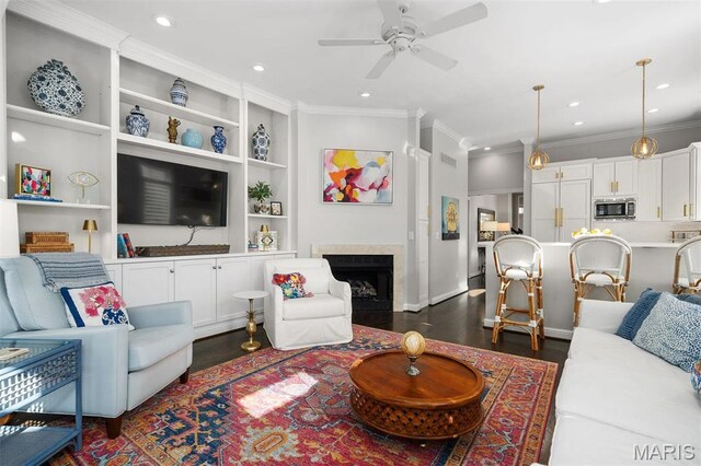 14 Brighton Way, Clayton, MO 63105 - living room featuring dark wood-style floors, ornamental molding, ceiling fan, recessed lighting, and built in features