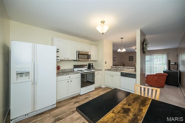 846 Sugar Valley Ct Unit 4, Saint Peters, MO 63376 - kitchen featuring white appliances, white cabinets, a chandelier, light wood finished floors, and decorative light fixtures