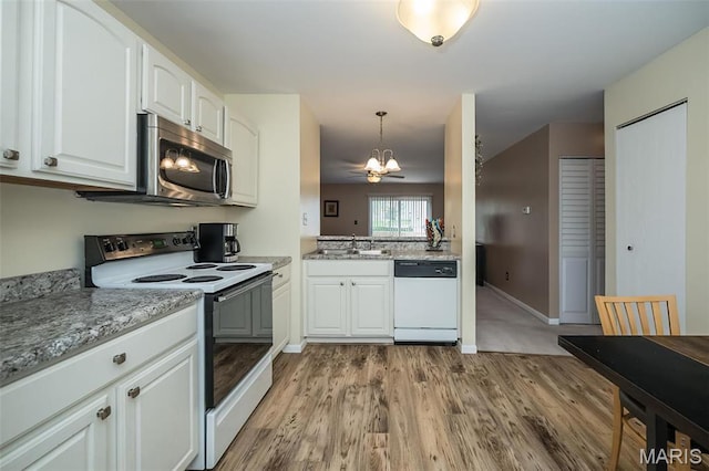 846 Sugar Valley Ct Unit 4, Saint Peters, MO 63376 - kitchen featuring dishwasher, electric range oven, stainless steel microwave, a chandelier, and light wood-type flooring