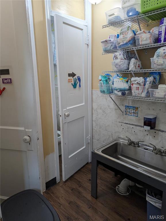 705 Burks Rd, Farmington, MO 63640 - washroom featuring wood finished floors and tile walls