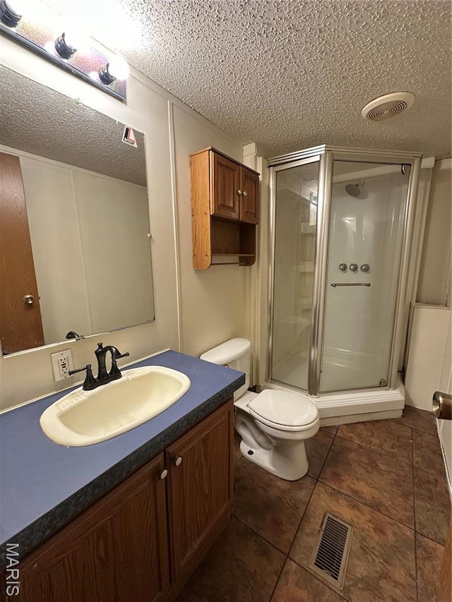 549 E Outer Rd, Sikeston, MO 63801 - full bathroom featuring a textured ceiling, a shower stall, vanity, tile patterned floors, and toilet
