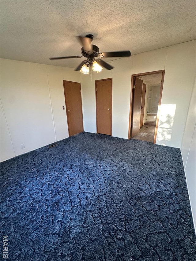 549 E Outer Rd, Sikeston, MO 63801 - unfurnished bedroom featuring carpet, a textured ceiling, and ceiling fan