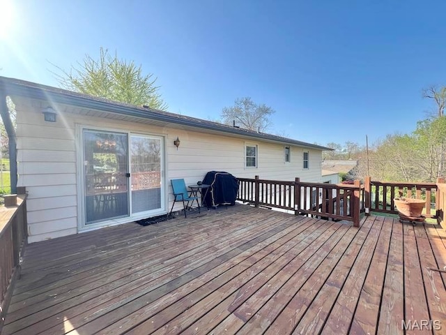 wooden terrace featuring area for grilling