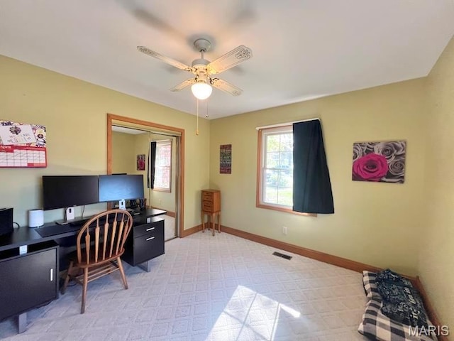 office space with ceiling fan, baseboards, and light carpet