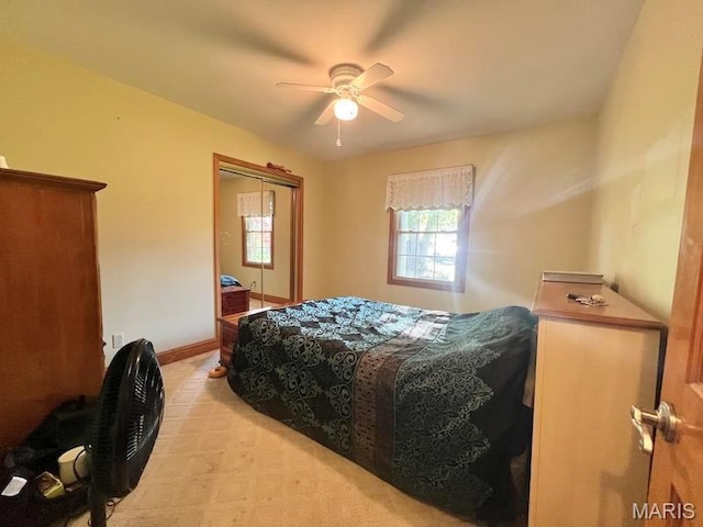 bedroom featuring light carpet, ceiling fan, and baseboards