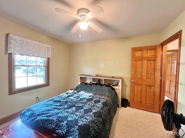 bedroom with a ceiling fan and baseboards