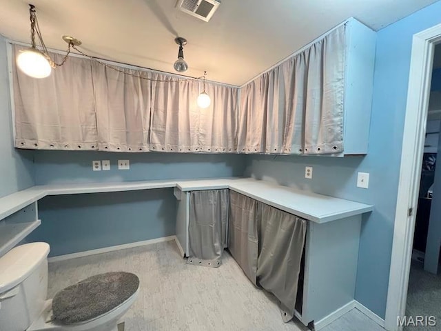 washroom with baseboards