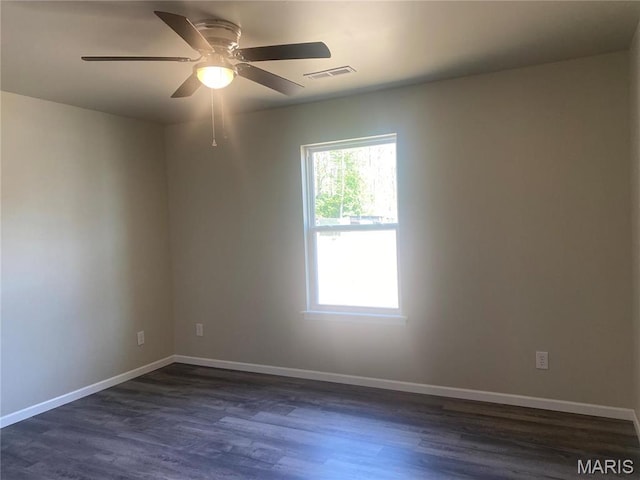 empty room with dark wood finished floors, baseboards, and ceiling fan