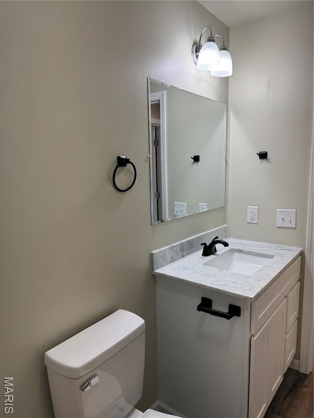 half bathroom with toilet and vanity