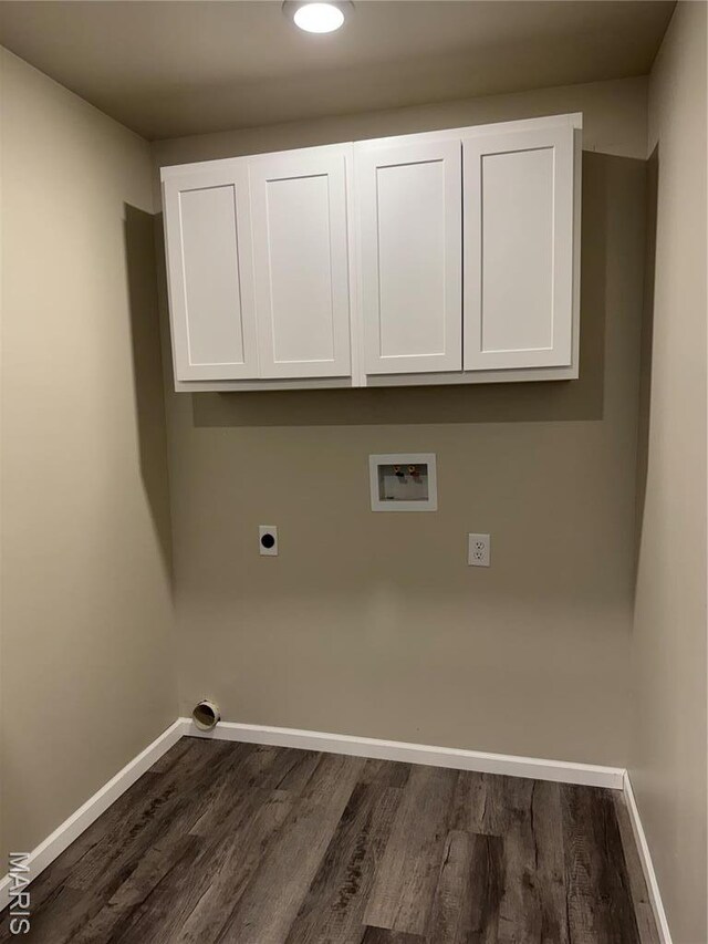 clothes washing area with hookup for an electric dryer, washer hookup, dark wood-type flooring, cabinet space, and baseboards
