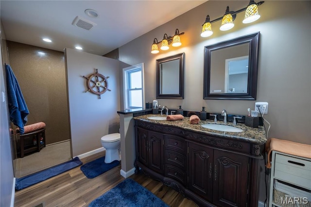 1753 Rue Marseilles, Bonne Terre, MO 63628 - full bath with wood finished floors, toilet, double vanity, recessed lighting, and baseboards