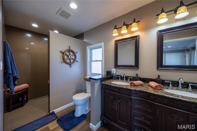 1753 Rue Marseilles, Bonne Terre, MO 63628 - bathroom featuring wood finished floors, double vanity, toilet, recessed lighting, and baseboards