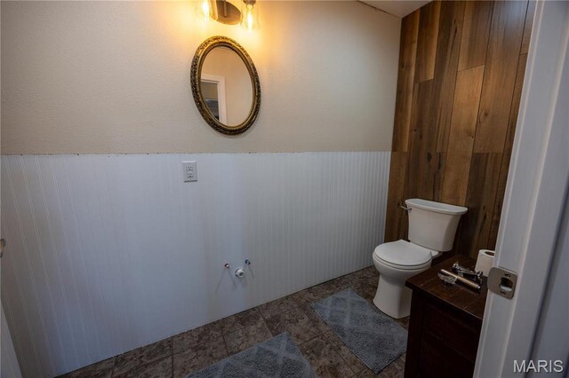 1753 Rue Marseilles, Bonne Terre, MO 63628 - half bathroom featuring wainscoting, toilet, and wooden walls