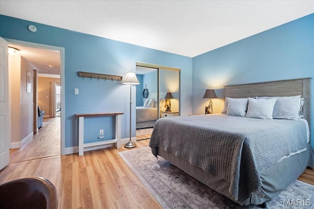 9005 Cardinal Ter, Saint Louis, MO 63144 - bedroom featuring wood finished floors, a closet, and baseboards
