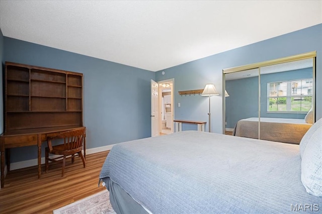 9005 Cardinal Ter, Saint Louis, MO 63144 - bedroom with wood finished floors, baseboards, and a closet