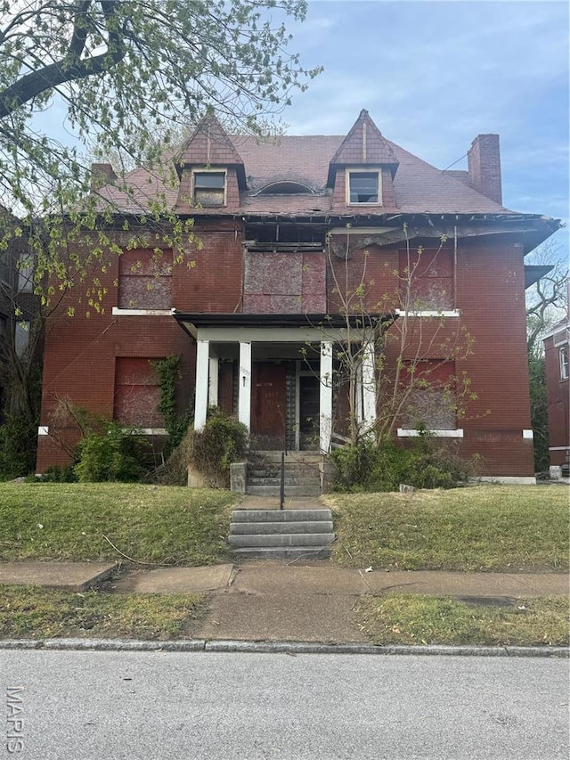5837 Cates Ave, Saint Louis, MO 63112 - view of front facade with a chimney and brick siding