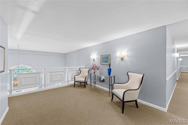 526 Sarah Ln Unit 27, Saint Louis, MO 63141 - sitting room with carpet flooring, baseboards, and an upstairs landing