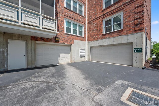 526 Sarah Ln Unit 27, Saint Louis, MO 63141 - garage featuring driveway and central AC unit