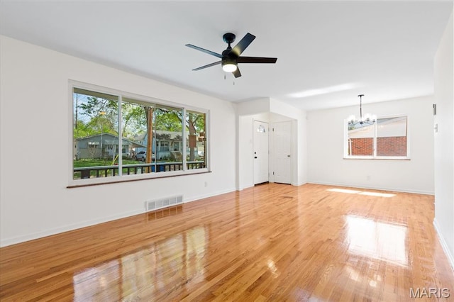 656 Beatrice Ave, Saint Louis, MO 63125 - unfurnished living room with a chandelier, wood finished floors, baseboards, and ceiling fan