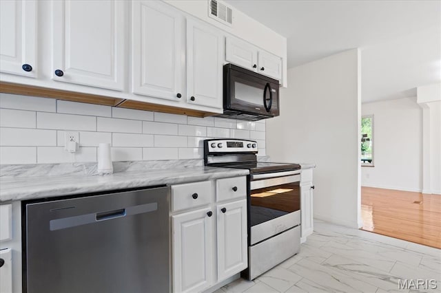 656 Beatrice Ave, Saint Louis, MO 63125 - kitchen featuring appliances with stainless steel finishes, light marble finish flooring, white cabinetry, and tasteful backsplash