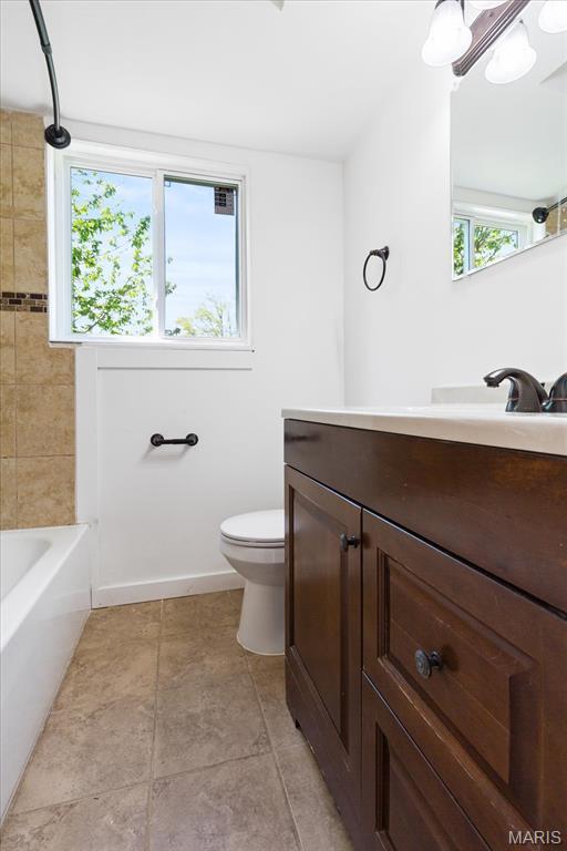 656 Beatrice Ave, Saint Louis, MO 63125 - full bath with toilet, vanity, tile patterned floors, and bathtub / shower combination