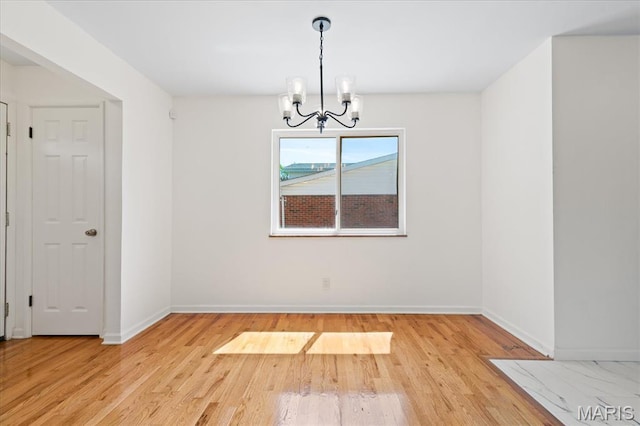 656 Beatrice Ave, Saint Louis, MO 63125 - spare room with a chandelier, light wood-style floors, and baseboards