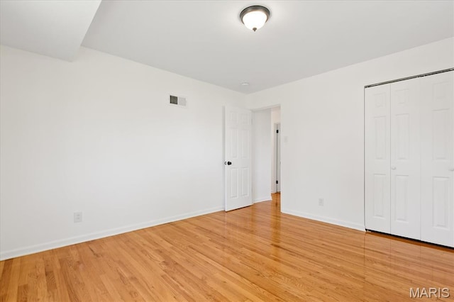 656 Beatrice Ave, Saint Louis, MO 63125 - unfurnished bedroom featuring light wood-type flooring, baseboards, and a closet