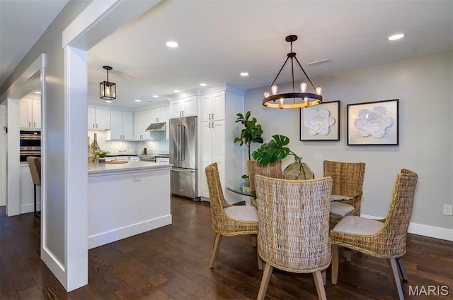 122 N Central Ave Unit A, Saint Louis, MO 63105 - dining space featuring a chandelier, dark wood finished floors, recessed lighting, and baseboards