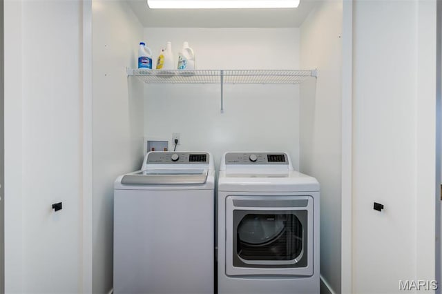 122 N Central Ave Unit A, Saint Louis, MO 63105 - clothes washing area featuring separate washer and dryer