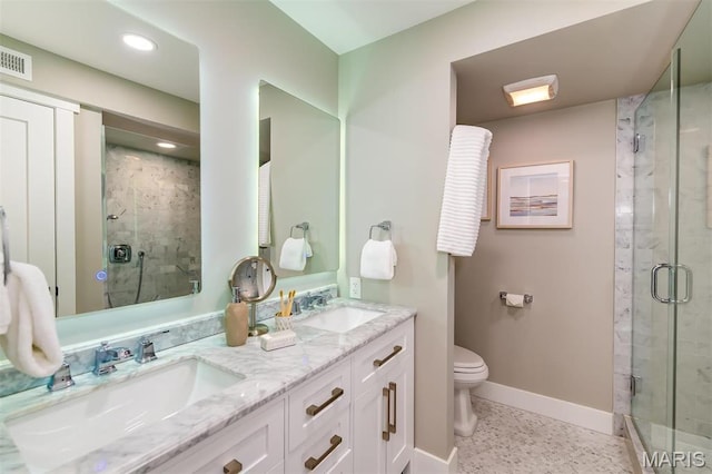 122 N Central Ave Unit A, Saint Louis, MO 63105 - bathroom with baseboards, a shower stall, toilet, double vanity, and recessed lighting
