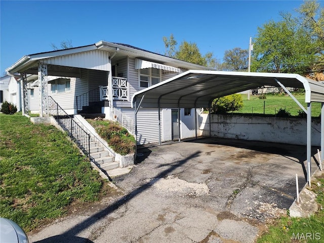 4028 Mcmasters Ave, Hannibal, MO 63401 - view of parking featuring a carport, driveway, and stairs
