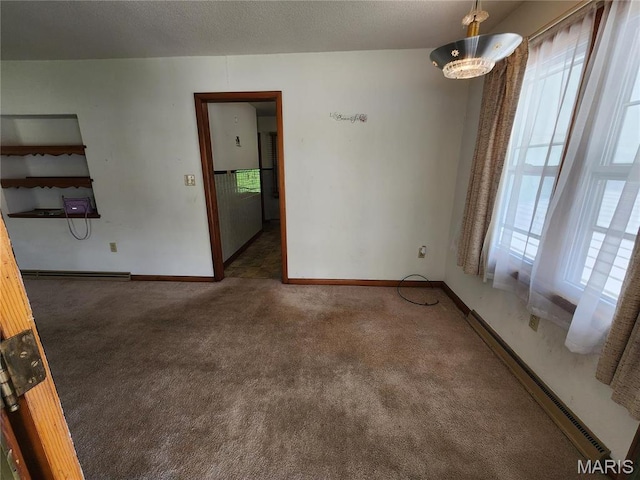 4028 Mcmasters Ave, Hannibal, MO 63401 - carpeted empty room with healthy amount of natural light, baseboard heating, and baseboards