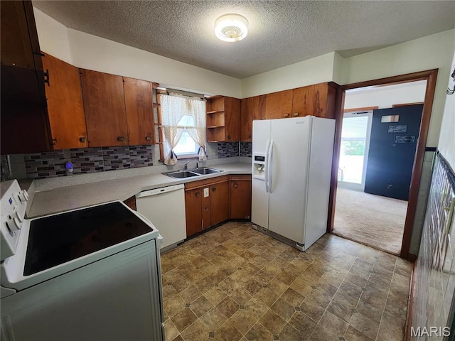 4028 Mcmasters Ave, Hannibal, MO 63401 - kitchen featuring white appliances, a sink, backsplash, a textured ceiling, and brown cabinetry